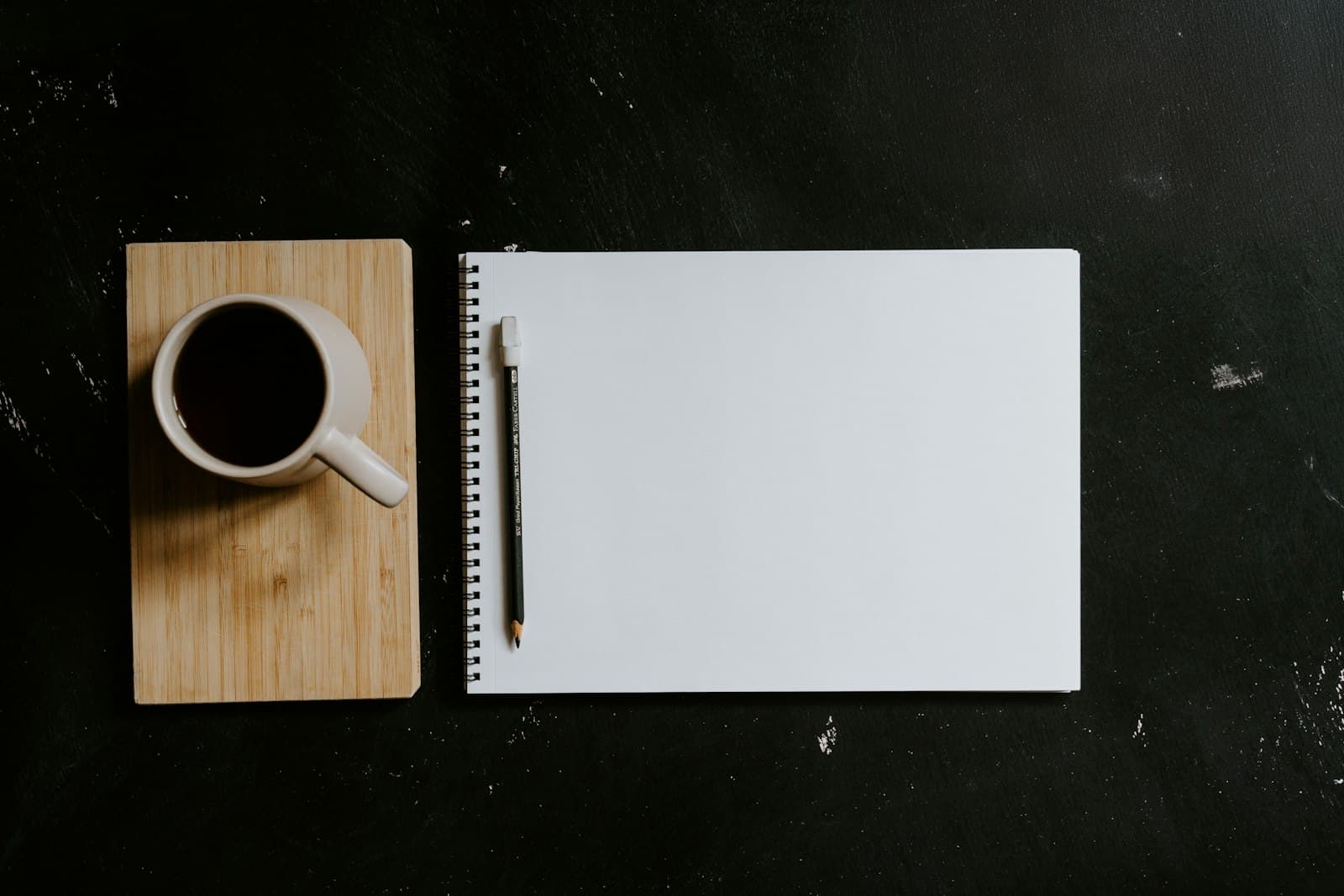 Coffee and journal on a desk during a quiet break.